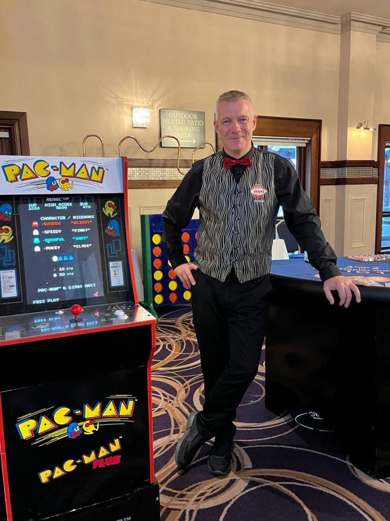 Crazy Vegas host beside a Pac-Man arcade machine