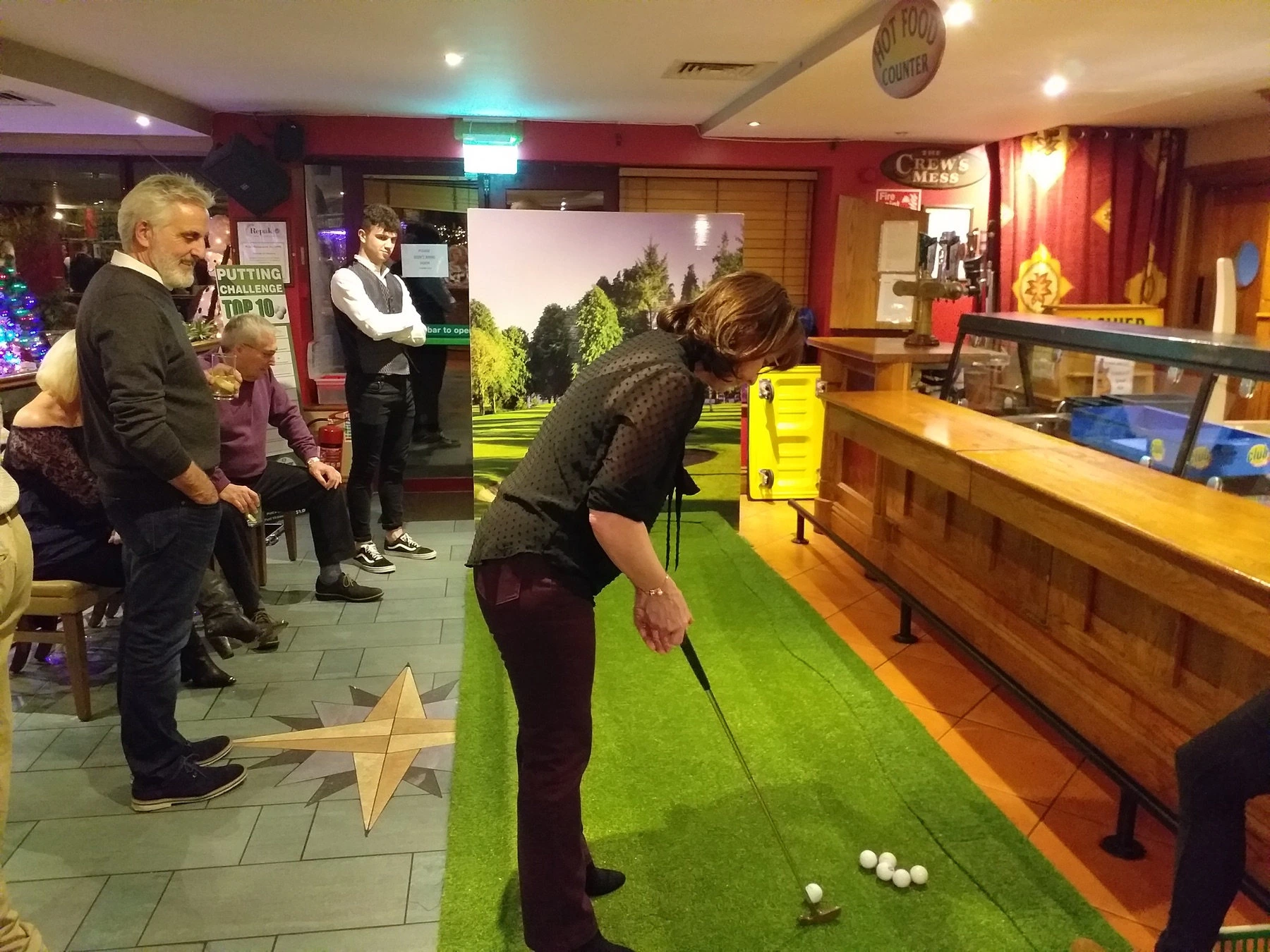 Guests playing mini golf at an event