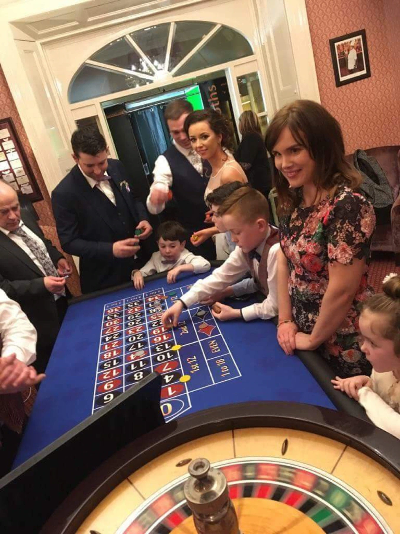 Guests gathered around a Crazy Vegas Roulette table